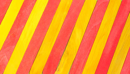 Colorful Ice Cream Stick. Red and yellow color. Diagonal abstract wooden sticks background. Colorful rainbow woodenの写真素材