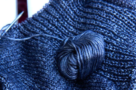 Needlework. Texture Knitted Fabric. Beautiful knitted blue fabric with metallic fibers and tangle as...