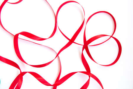 Bright festive red ribbon and curl isolated on white background
