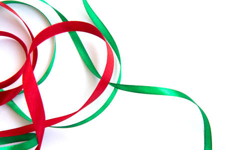 Bright festive red and green ribbon and curl isolated on white backgroundの写真素材