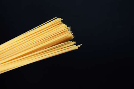 Raw spaghetti isolated on black background. Pasta. Selective focusの写真素材