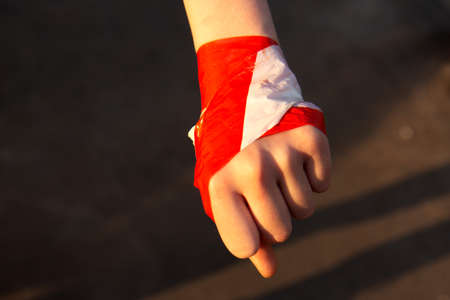 Hand holding red and white protective tape. Keep a social distance. To avoid coronavirus covid-19 transmissionの写真素材
