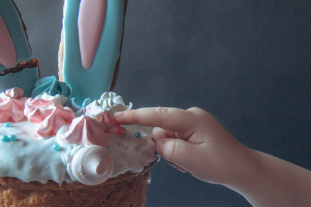 Traditional delicious Easter cake with marshmallow and rabbit ears on contrast background. Child...