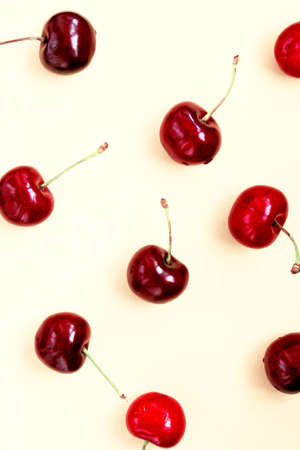 Bright red cherry on light background. Cherry pattern. Cherries close up. Summer flat lay berry...