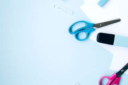 School stationery and supplies on blue background with space for caption. Back to school, homeschool creative workspace. Minimalistic set of colorful stationery. Flat layの写真素材