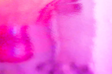 Blurred pink trendy backdrop. Bright holographic foil background. Colorful blue, red, purple background. Flat layの写真素材