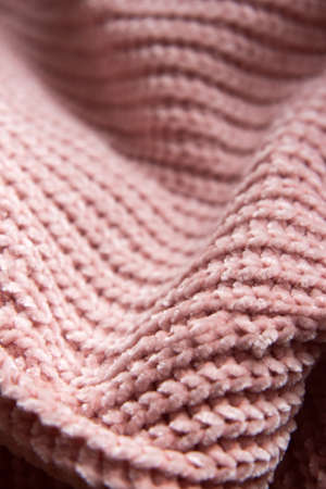 The beautiful texture of the knitted fabric. Knitted nude pink fabric as background. Copy spaceの写真素材