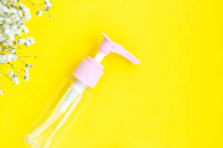Mock up cosmetic jar for cream, shampoo, serum on bright yellow paper background with shadows. Top...