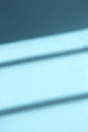 Blue background with contrasting shadows. Abstract trending background with shadows