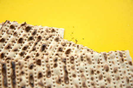Traditional Jewish kosher matzo for Passover. Set with Passover matzos on yellow background. Pesach...
