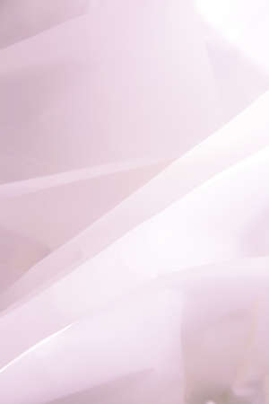 Beautiful pink abstract background with folds and bends of paper. Draped background. Copy spaceの写真素材