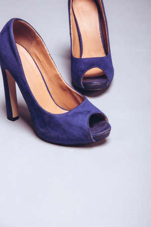 Womens violet worn shoes high heels on gray background. After party, fashion concept. Side viewの写真素材