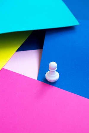 Abstract background. White chess figure on a bright colorful background. Pawn on a bright background. Colorful chess conceptの写真素材