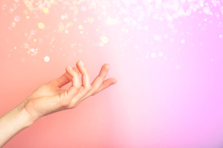 Beautiful female hand isolated on multicolored neon background with blur. Palm up, close up. High resolution productの写真素材