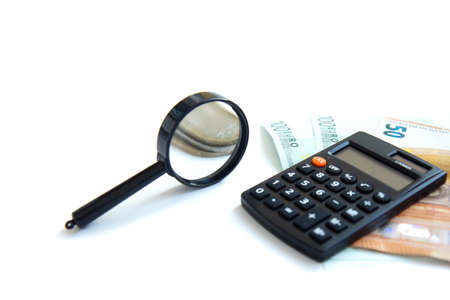Calculator, paper money and stack of coins isolated on white background. Family budget concept and investing. Close upの写真素材