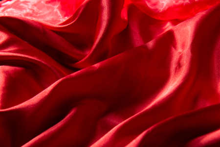 Beautiful red silk background. Draped background of fabric, texture