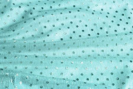 Beautiful nude green tulle with shiny sequins background. Draped background of pink powdery fabric, texture. copyspace. close upの写真素材