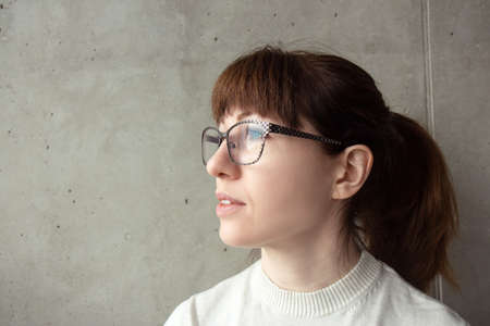 Portrait of a young red-haired woman in glassesの写真素材