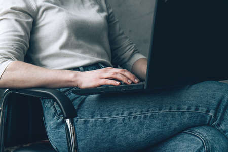 Woman working on a laptop at her home workplace. close upの写真素材
