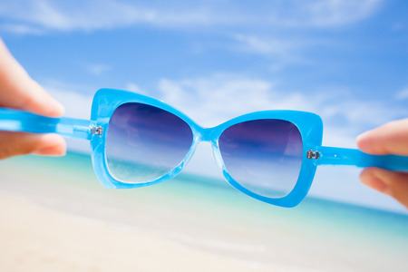 close up of fancy sunglasses. sunny beach in thailandの写真素材