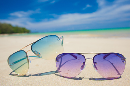pair of bright sunglasses on tropical Thailand beach. travel conceptの写真素材