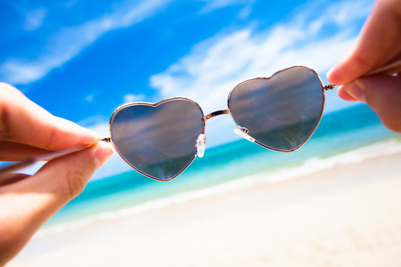 close up of heart-shaped sunglasses. sunny beach in thailandの写真素材
