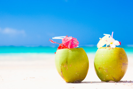 two fresh coconut cocktails on tropical beachの写真素材