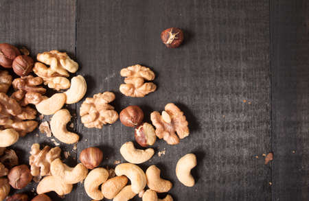 Assorted nuts in on wooden deckの写真素材