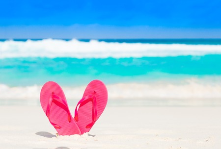 Pink flip flops over a tropical sea resort backgroundの写真素材