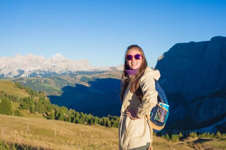 Young woman hiking at Passo Gardena, Dolomites, Italyの写真素材