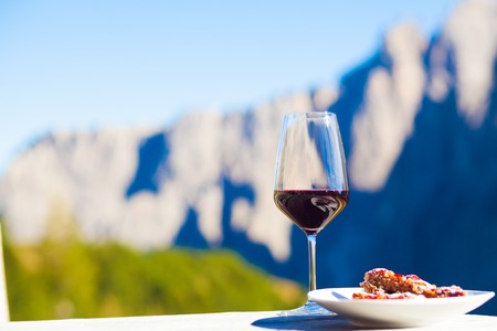 Glass of chilled white wine on a rocky mountain background.