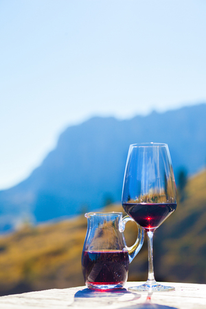 Glass of chilled white wine on a rocky mountain background.の写真素材