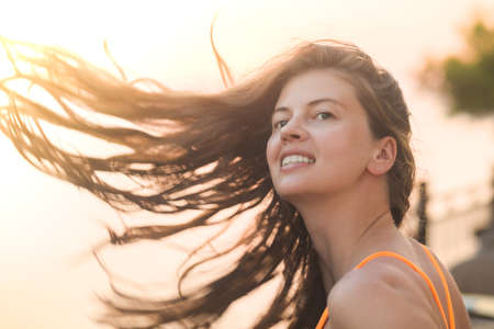 Happy vacation woman on beach summer holiday in cheerful bliss enjoying the sunshine. Beautiful girlの写真素材