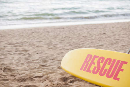 Yellow surf rescue board by the sea beach.の写真素材