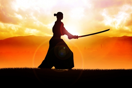 Silhouette of a samurai posing during sunset の写真素材