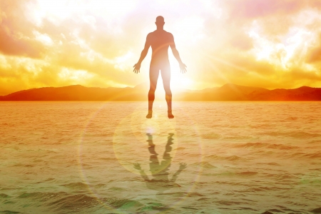 Silhouette illustration of human figure floating on water の写真素材