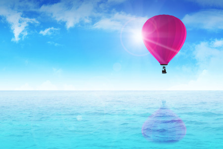 An air balloon floating on blue waterの写真素材