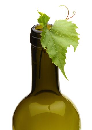 wine bottle and green grape vineの写真素材