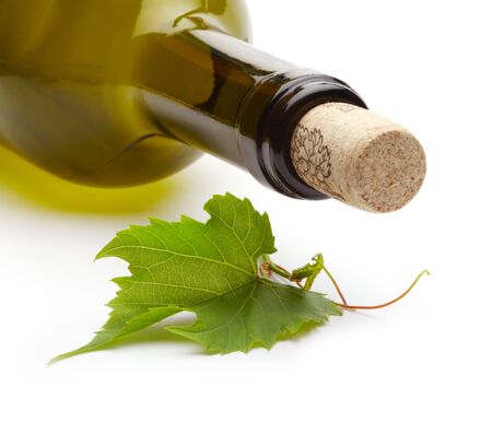 wine bottle and green grape vineの写真素材