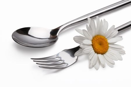 fork and spoon with chamomile flowerの写真素材