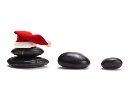 stack of stones with red santa claus hatの写真素材
