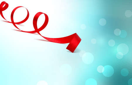 red satin ribbon on blue soft backgroundの写真素材