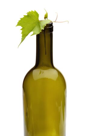 wine bottle and green grape vineの写真素材