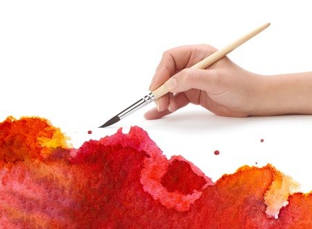hand with brush and watercolor paintの写真素材