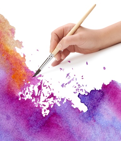 hand with brush and watercolor paintの写真素材