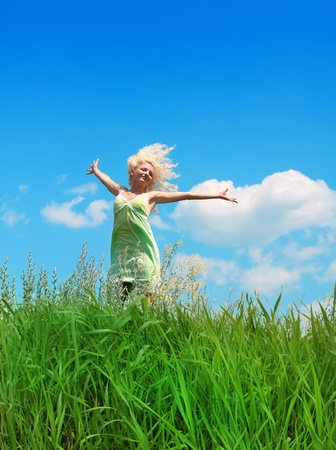 young woman under blue skyの写真素材