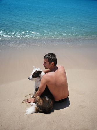 man with dog on seaの写真素材