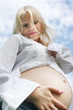 Outdoor portrait of beautiful pregnant womanの写真素材