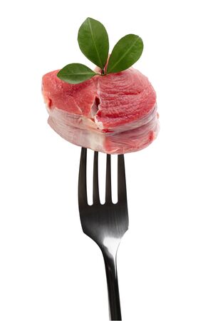 fork with raw meatの写真素材