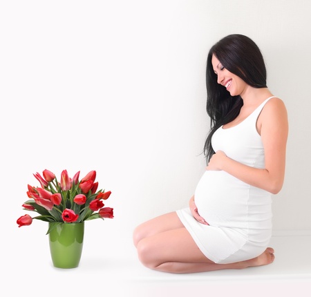 pregnant woman with tulips bouquetの写真素材